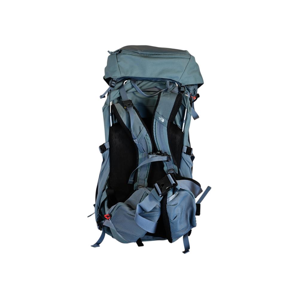 Blue hiking backpack by North Face with adjustable straps and external pockets on a white background.