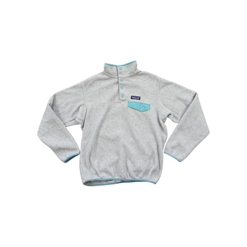 Gray fleece pullover by Patagonia with snap placket and blue trim on the collar, pocket, and hem.