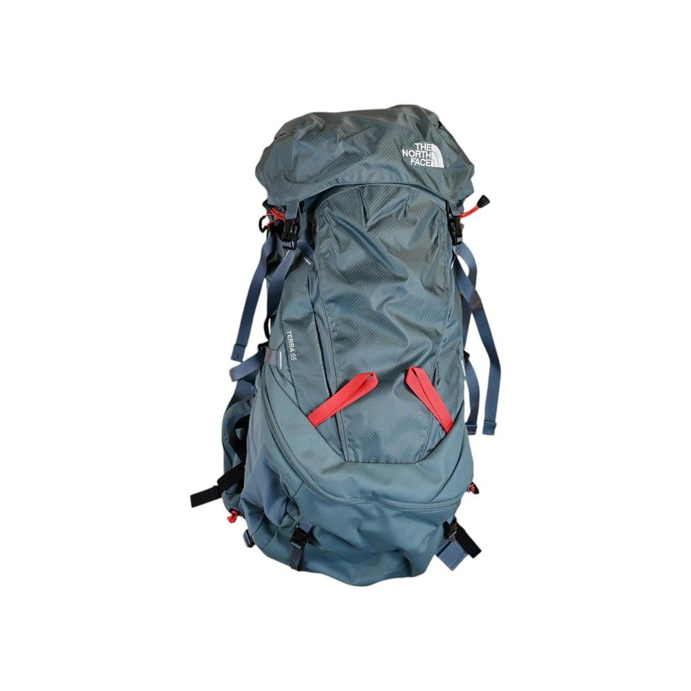 Blue hiking backpack by North Face with red straps and compression buckles.