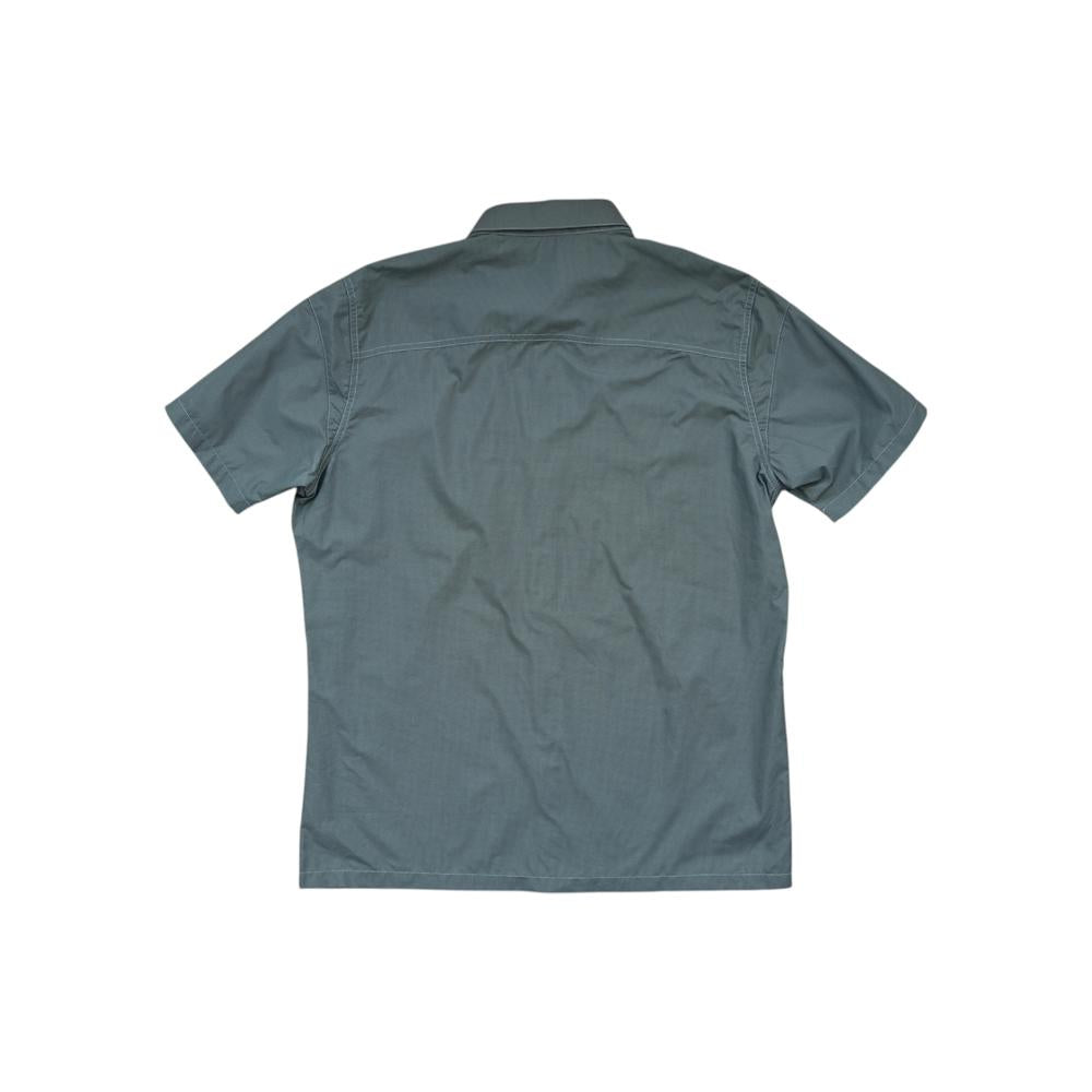Green button-down shirt by Kuhl, seen from the back with short sleeves and a classic collar.