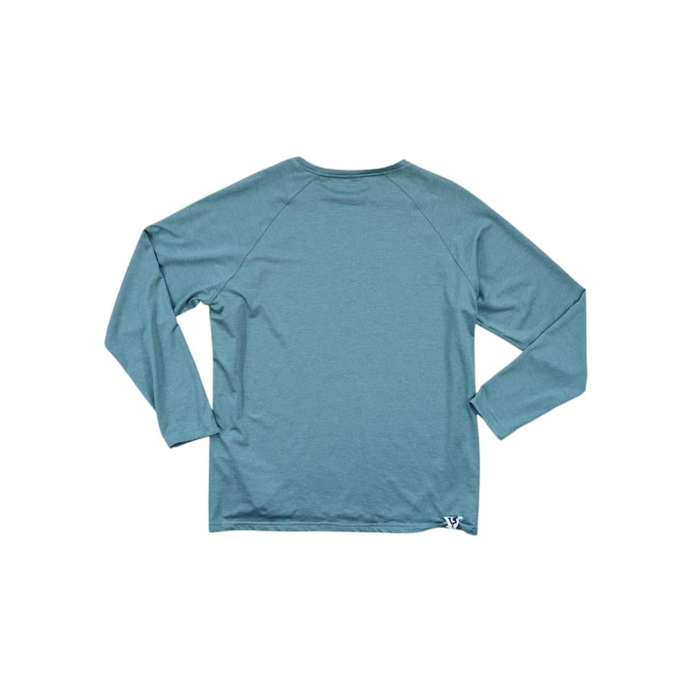 Blue long sleeve shirt by Flylow with a small logo on the lower hem.