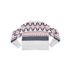 Patterned knit sweater by Kari Traa with zigzag, stripe, and diamond motifs.