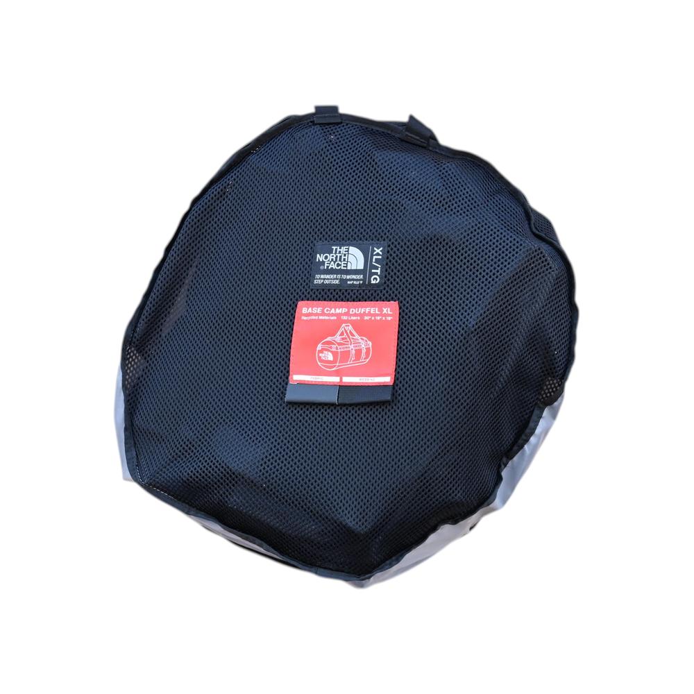 Black extra-large duffel bag by North Face in a mesh carry case with a product tag.