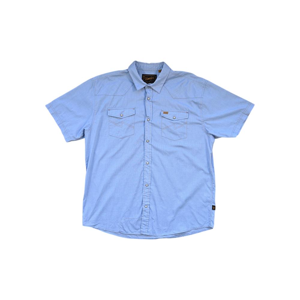 Light blue short-sleeve shirt by Howler Bros featuring western-style pockets and snap closures.