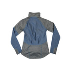 Blue softshell jacket by Mountain Hardwear with grey sleeves and a mock neck.