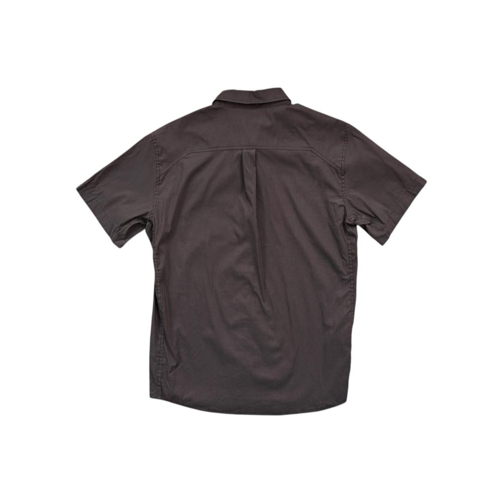 Brown button-down shirt by Arcteryx, seen from the back with short sleeves and a box pleat.