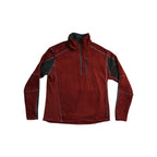 Red quarter-zip fleece by Kuhl, with black shoulder panels and subtle gray contrast stitching.