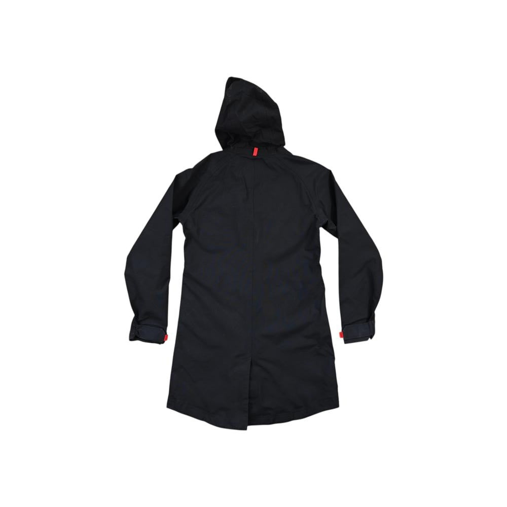 Black rain shell jacket by Topo Designs, featuring a hood and red detail on the sleeves and back.