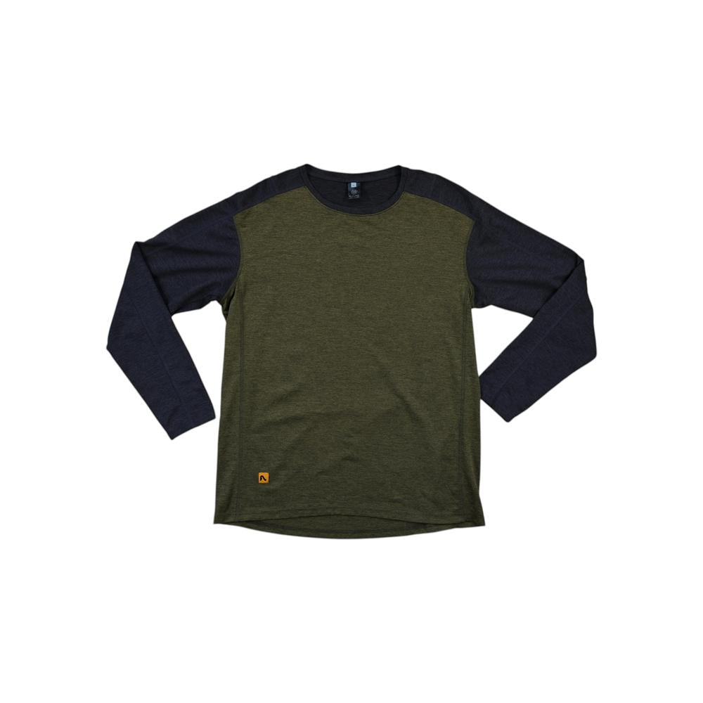 Two-tone baselayer long sleeve shirt by Flylow, in green and black, with a small logo on the front.