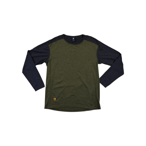 Two-tone baselayer long sleeve shirt by Flylow, in green and black, with a small logo on the front.