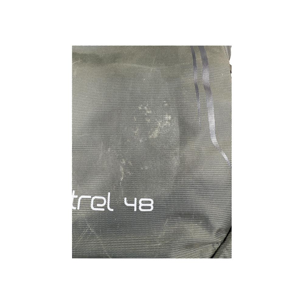 Grey backpack by Osprey, showing a subtle grid-like texture with straps and a visible product name.
