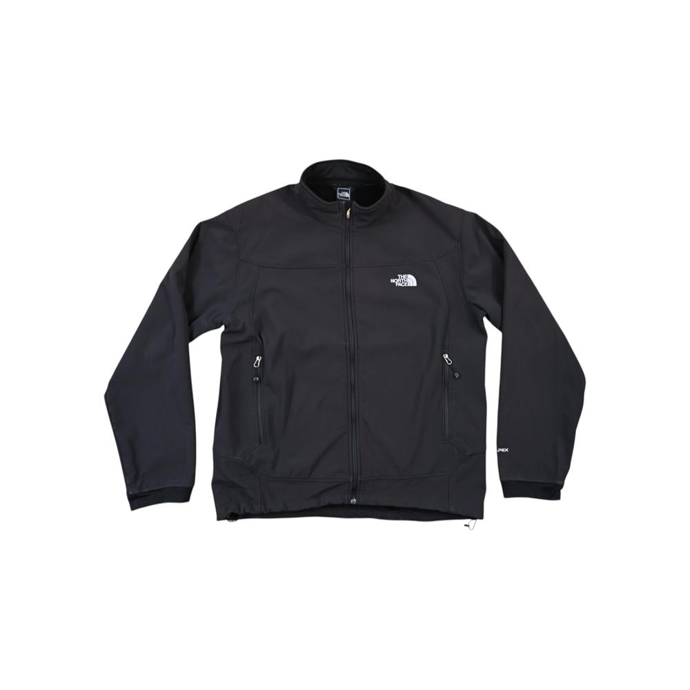 Black softshell jacket by North Face with fleece lining, featuring a zip-up front and side pockets.