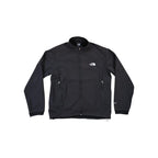 Black softshell jacket by North Face with fleece lining, featuring a zip-up front and side pockets.