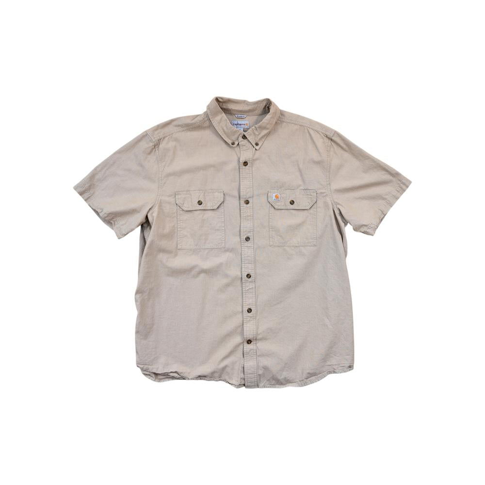 Tan button-up shirt by Carhartt, featuring short sleeves, two chest pockets, and brown buttons.