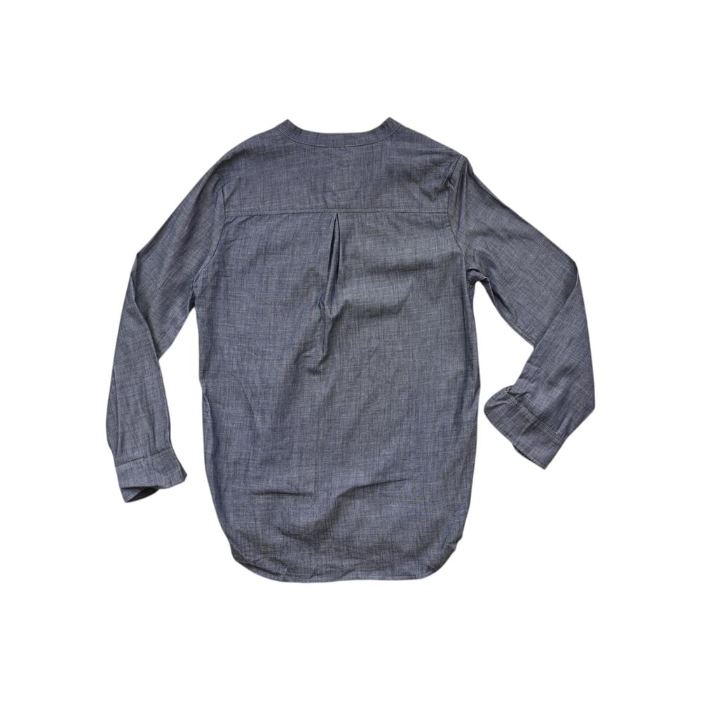 Blue chambray popover shirt by Topo Designs with long sleeves and a rounded hem, back view.