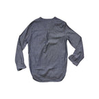 Blue chambray popover shirt by Topo Designs with long sleeves and a rounded hem, back view.