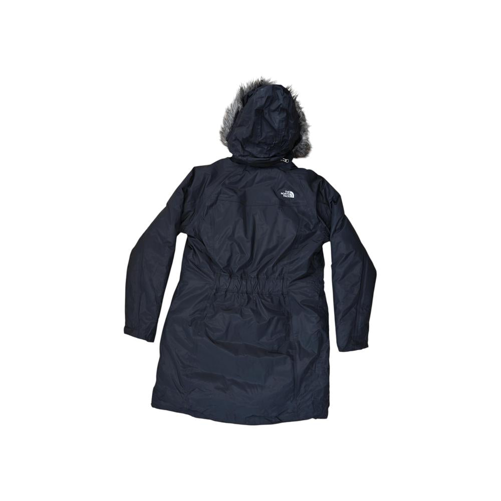 Black insulated parka jacket by North Face with a fur-trimmed hood, back view.