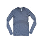 Gray long sleeve shirt by Lululemon with a fitted silhouette and breathable texture.